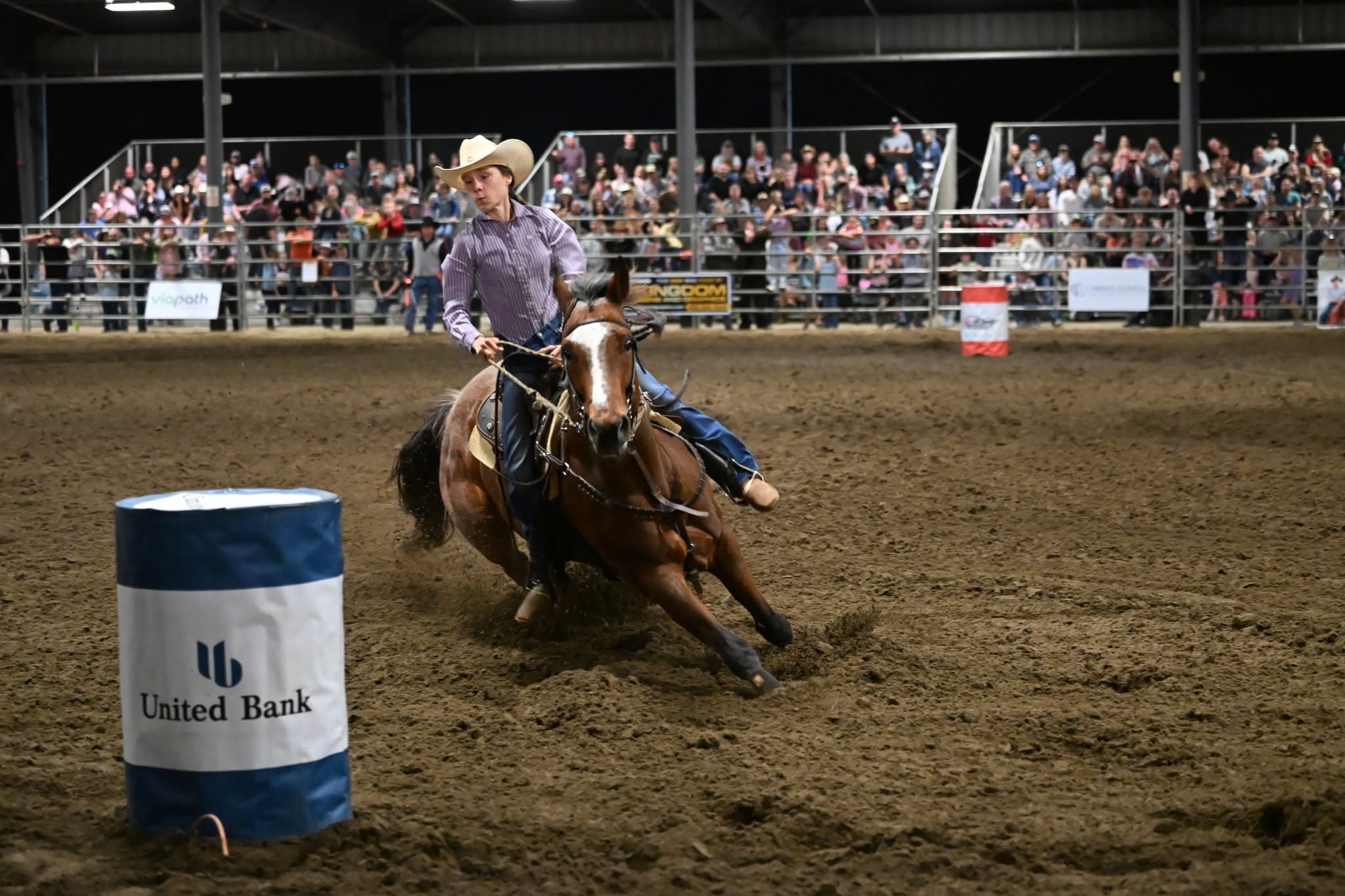 Barrel racer turning around a barrel at the Sheriff’s Rodeo
